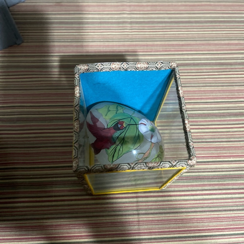 Vintage and painted egg in a glass box